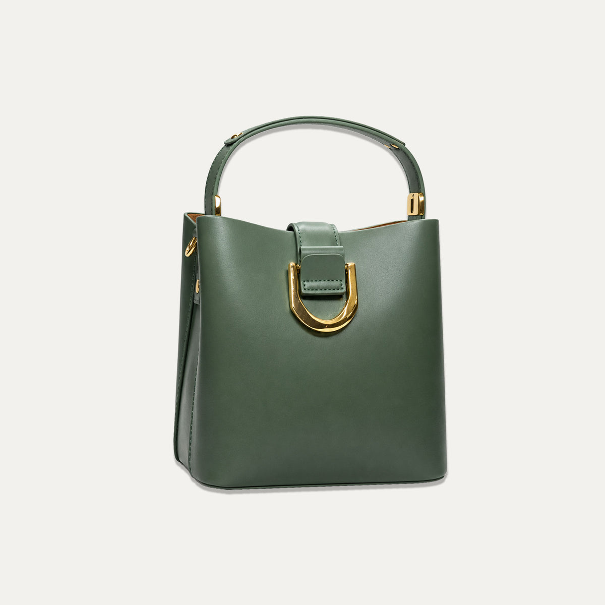 A structured dark green leather handbag with a top handle, a large gold-tone U-shaped hardware accent on the front, and gold-tone hardware on the handle, shown against a light off-white background.
