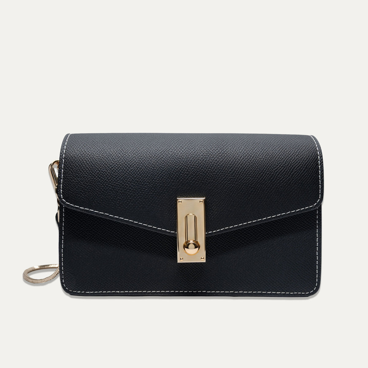 A black textured leather crossbody bag with white contrast stitching and a gold-tone turn-lock clasp, shown against a light off-white background.