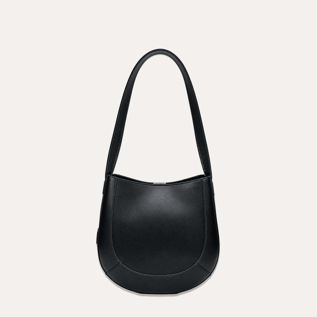 A black leather crescent-shaped shoulder bag with a single strap, photographed against a light off-white background.